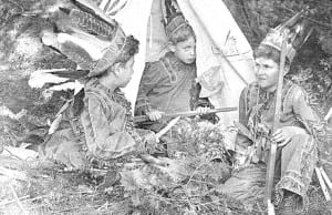 Young Bob plays peek-a-boo in a tepee.