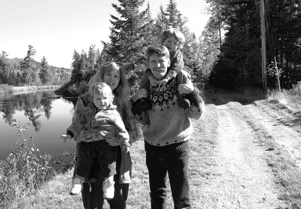 The Kanze family—Debbie with daughter Tasman, Ed with son Ned—near their home on the Saranac.