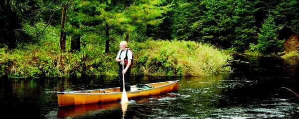 A canoeist practices his balancing act on the Jordan River.