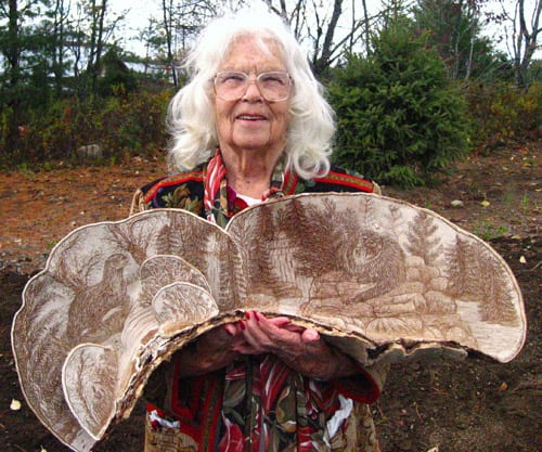 Nellie Staves shows off one of her fungus etchings.
