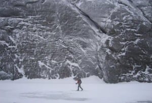Avy pass web A skier crosses Avalanche Lake near the cliffs of Mount Colden.