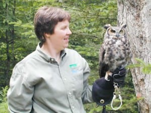 A naturalist with an owl at the Newcomb VIC.