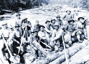 Rivermen take a break during the spring log drive on the Bog River, 1900.