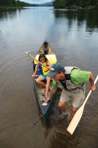 Jack brings his daughter, Zoe, safely ashore. Photo by Lisa Densmore