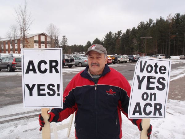 Tupper Lake resident James Lanthier demonstrates outside the APA in favor of the Adirondack Club and Resort. Photo by Phil Brown. 