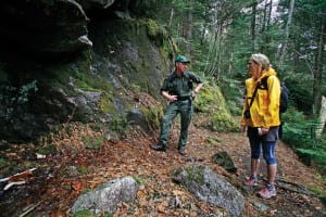 Forest Ranger Charlie Platt talks with hiker Kelly Paganelli along the trail to Indian Head in Keene. Photo by Nancie Battaglia