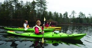 Three of the authors, Carol Moseman (left), Kathy DeLong (center), and Ruth Dandrea, paddle on Long Lake.