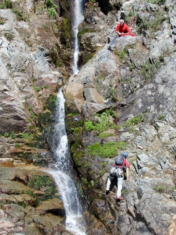 After crossing the stream, R.L. belays his follower.