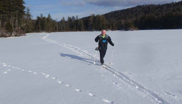 Tim O'Keefe glides across Cascade Lake on a perfect winter day. Photo by Phil Brown