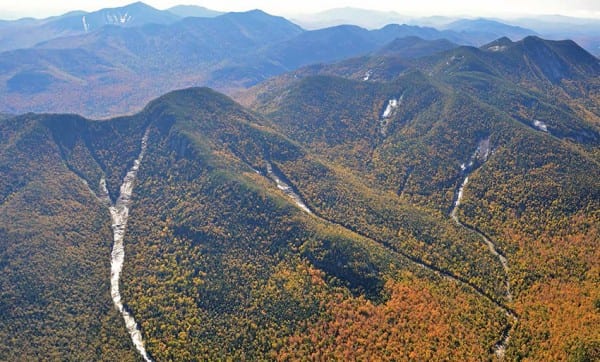 The aerial photo shows slides on Lower and Upper Wolf Jaw mountains that were created or enlarged by Tropical Storm Irene. Photo by Kevin MacKenzie