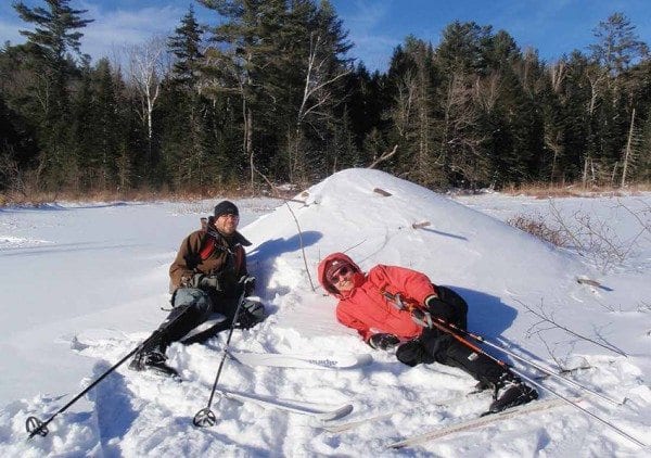 Ethan and Kim take a break at a beaver lodge. Photo by Phil Brown.