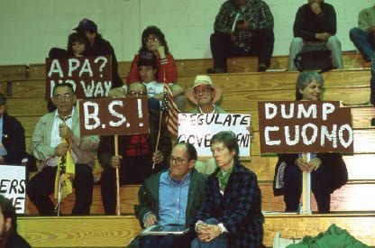 Many protesters brought placards to the Cuomo commission’s hearing in Saranac Lake in 1990.  PHOTO BY NANCIE BATTAGLIA
