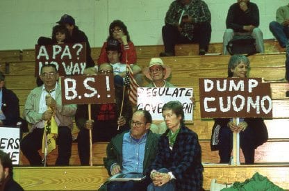 Many protesters brought placards to the Cuomo commission’s hearing in Saranac Lake in 1990. PHOTO BY NANCIE BATTAGLIA