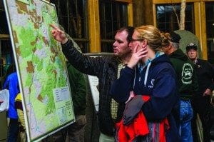 Matt McNamara and Meg Parker check out a map of the rail corridor at the Wild Center. Photo by Nancie Battaglia