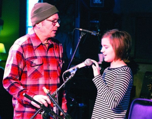 Scott Renderer helps Phoebe Amirault with a sound check at January Jams. Photo by Mike Lynch