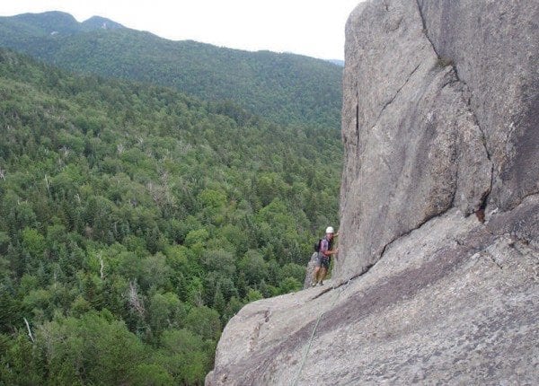 On the third pitch, climbers traverse a broad ledge with a wild, airy feel.