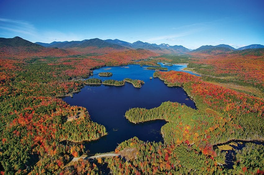 The High Peaks form the backdrop of Boreas Ponds. The state must decide what to do with the lodge and dam visible near the south end of the ponds. Photo by Carl Heilman II/Courtesy of Adirondack Council