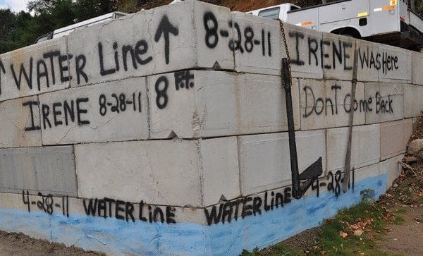 Two major floods hit the Ausable River valley in 2011, one in April, one in August. This wall at Fred’s Auto Repair near Ausable Forks shows the high-water marks. Photo by Kenneth Aaron
