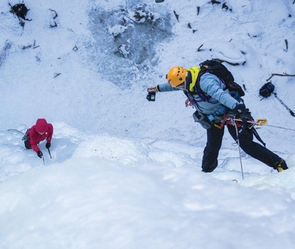 While hanging from a rope, R.L. Stolz photographs Sabrina’s ascent. Photo by Karen Stolz/Veritcal Perspectives Photography