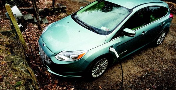 The Halasz family's electric car is hooked up to a charger at their home in Saranac Lake. Photo by Mike Lynch