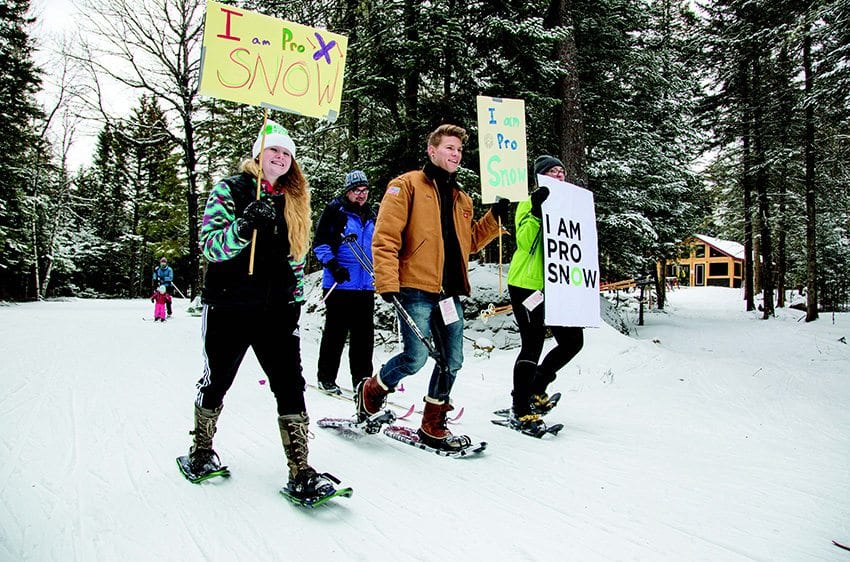 Adirondack Youth Climate Summit students hold an ”I Am Pro Snow” rally at Mount Van Hoevenberg in January. Photo by Mike Lynch