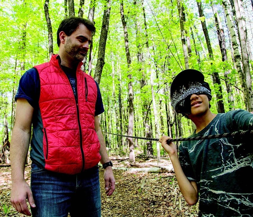 Brian DeGroat watches a camper navigate a sensory-awareness exercise. PHOTO BY MIKE LYNCH