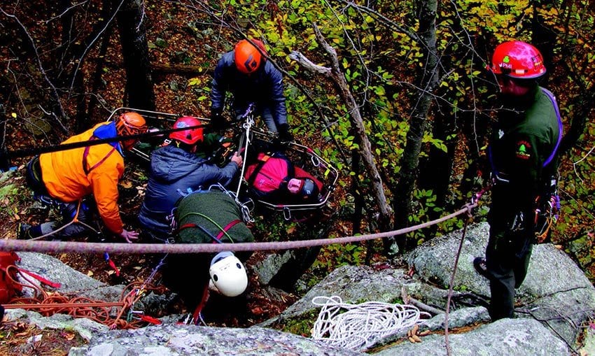 A forest ranger lowers a litter during training at Lake George. PHOTO BY KAREN STOLZ / VERTICAL PERSPECTIVES PHOTOGRAPHY