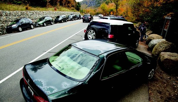 The high number of cars lining Route 73 at popular trailheads has raised safety concerns. PHOTO BY MIKE LYNCH