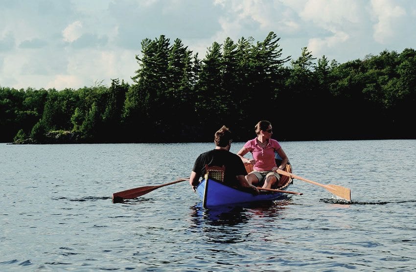 Allison Warner and Rob Davidson take a new boat for a test drive on Moose Pond near Saranac Lake. PHOTO BY SUSAN BIBEAU