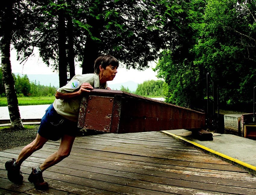 Margaret Hawthorn uses a wooden arm and muscle power to operate the upper locks.