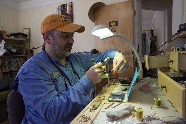 Wiley's Flies owner Vince Wilcox ties a fly in his Ray Brook shop in 2017. Photo by Mike Lynch