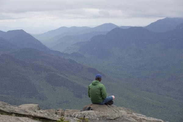 A hiker takes in the views from Giant Mountain this past spring, finding solitude on an otherwise busy weekend.