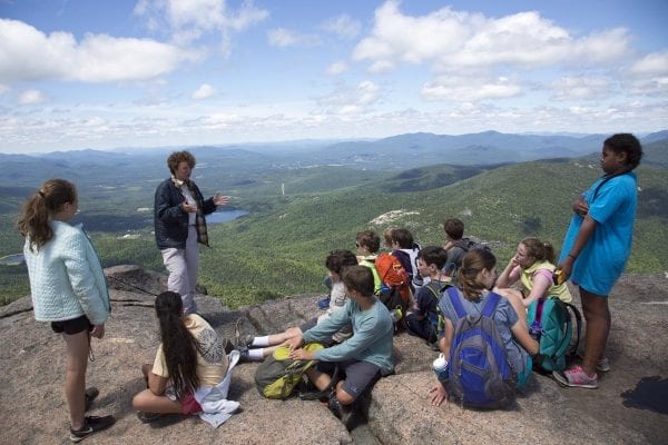 A summit steward talks to hikers on Cascade Mountain.