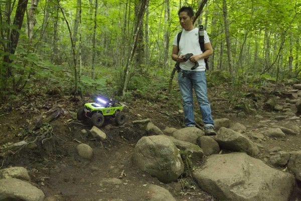 A man drives his toy car down Cascade Mountain, likely a violation because the toy is a motorized vehicle being used in a Wilderness area.