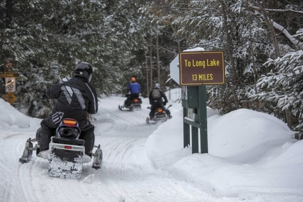 Snowmobilers ride from Newcomb to Long Lake. Photo by Mike Lynch