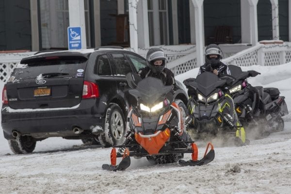 Snowmobilers head back out after a break in Long Lake. Photo by Mike Lynch