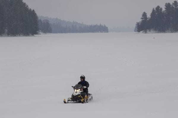 A lone snowmobiler on Long Lake in Hamilton County. Photo by Mike Lynch