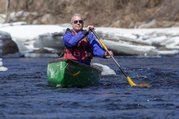 Marty Plante runs the Cedar River in early April, when conditions were still winterlike. Photo by Mike Lynch
