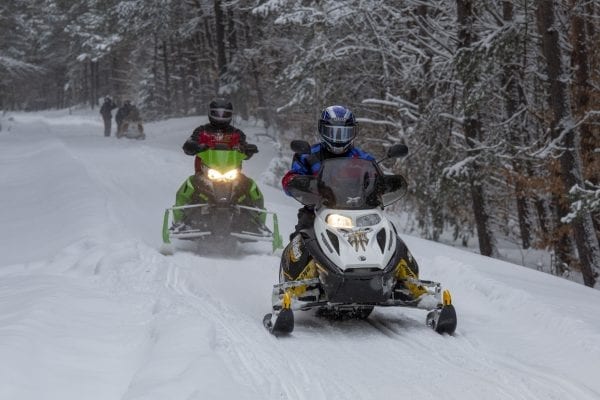 Snowmobilers ride the railroad corridor in Lake Clear. Photo by Mike Lynch