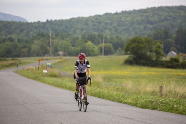 A Cycle Adirondacks participant rides through farmlands in the Champlain Valley. Photo by Mike Lynch