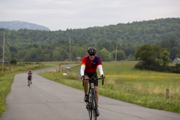 A Cycle Adirondacks participant rides through farmlands in the Champlain Valley. Photo by Mike Lynch