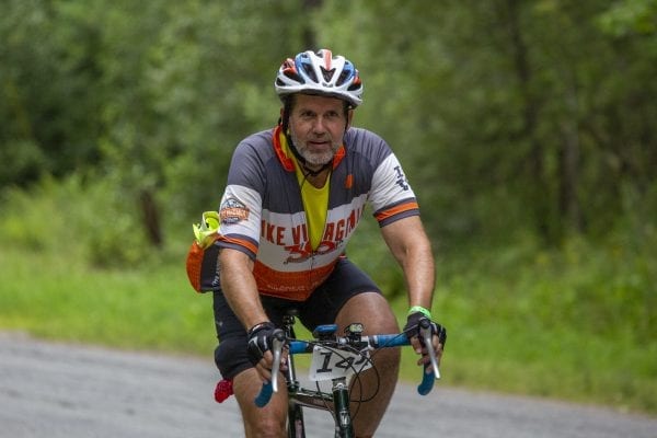 A Cycle Adirondacks participant rides through farmlands in the Champlain Valley. Photo by Mike Lynch