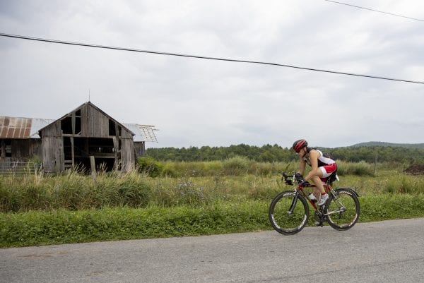 A Cycle Adirondacks participant rides through farmlands in the Champlain Valley. Photo by Mike Lynch