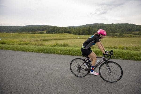 A Cycle Adirondacks participant rides through farmlands in the Champlain Valley. Photo by Mike Lynch
