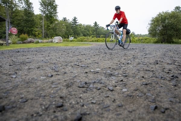 A Cycle Adirondacks participant enters Reber Rock Farm for a scheduled lunch break. Photo by Mike Lynch