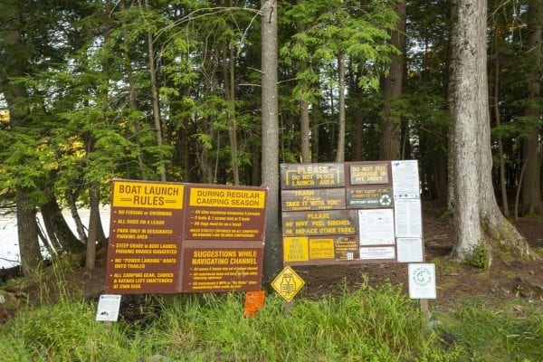 Signs at the Second Pond state boat launch, which provides access to Lower Saranac Lake. Photo by Mike Lynch