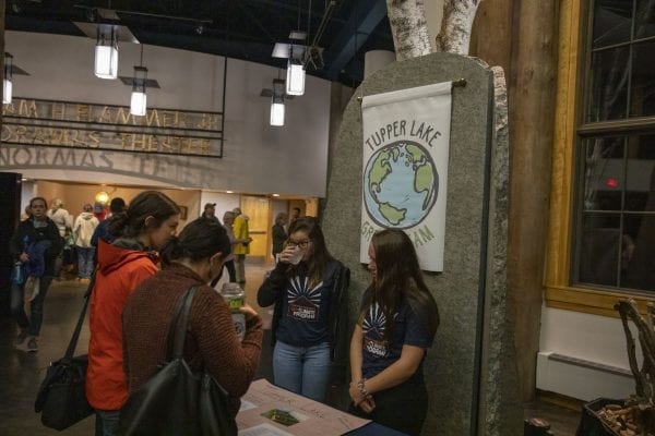 Students set up displays in the lobby at The Wild Center for the event. Photo by Mike Lynch