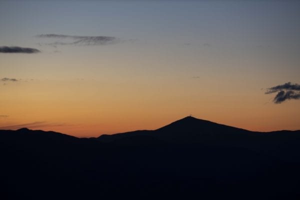 Whiteface Mountain surrounded by the orange glow of sunset. Photo by Mike Lynch