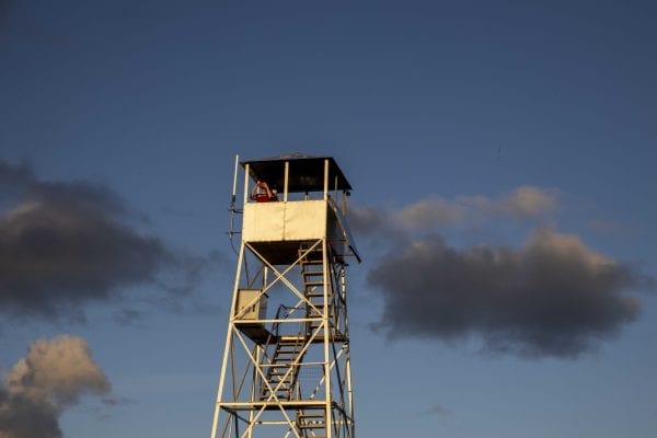 The Hurricane Mountain fire tower lit up by the sun shortly before sunset. Photo by Mike Lynch