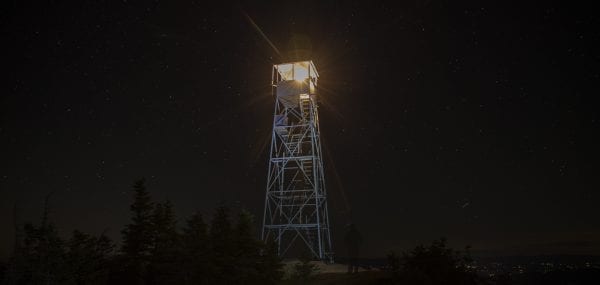 The fire tower cab was lit by a lantern Saturday night. Photo by Mike Lynch